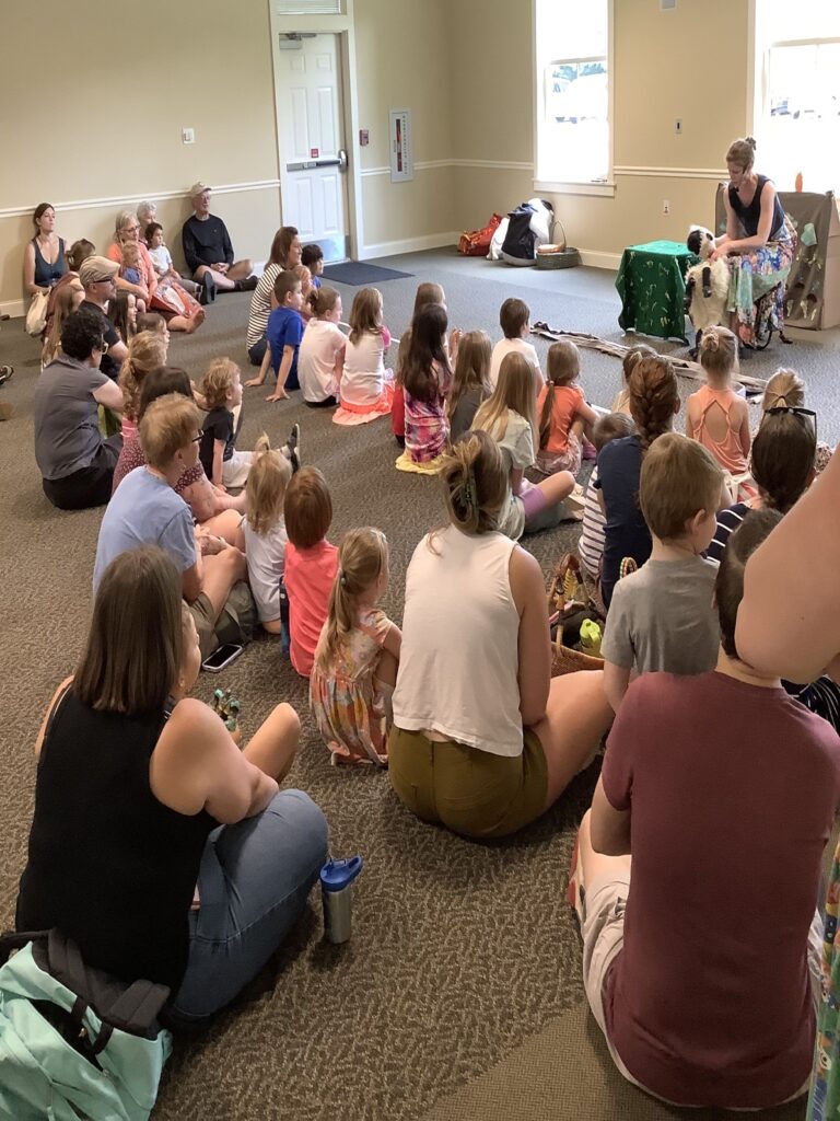 photo of community members watching a puppet show